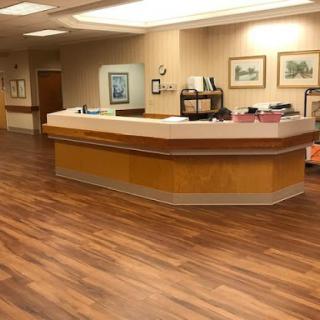 A well-lit reception area featuring a wooden counter and elegant decor.