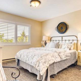 A cozy bedroom with a metal bed frame, soft bedding, and warm lighting.