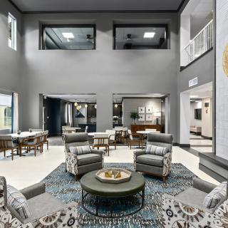 A modern and luxurious lobby featuring a seating area with stylish furniture and elegant decor.