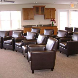 A cozy seating area with leather chairs arranged in a living room setting.