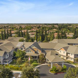 Aerial view of a suburban residential neighborhood surrounded by trees.