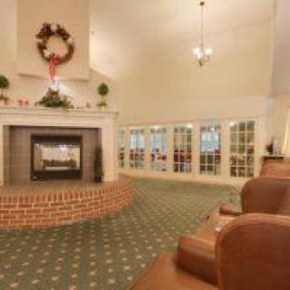 A cozy living room with a decorated fireplace and comfortable seating.