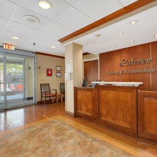 A welcoming reception area with a wooden desk and seating nearby.
