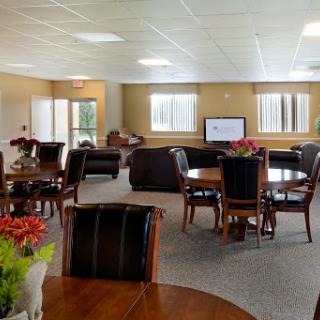 A spacious lounge area featuring comfortable seating and dining tables, perfect for community gatherings.