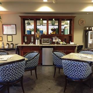 A cozy cafe interior with patterned chairs and a well-organized counter.
