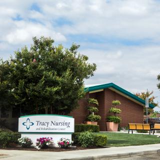 A nursing home building with well-maintained landscaping and clear signage.