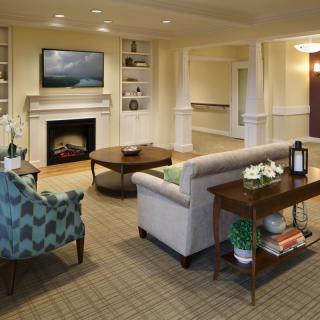 A cozy living room with a fireplace and comfortable seating area.