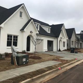 A row of modern suburban homes on a cloudy day.