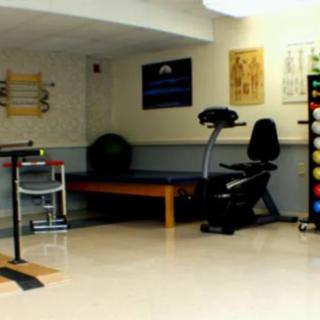 A small gym with fitness equipment and an exercise bike.