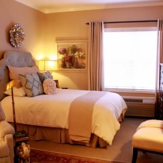 A cozy and well-decorated bedroom with warm lighting and comfortable furnishings.