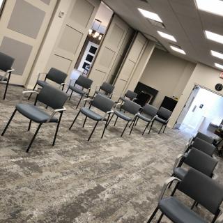 An indoor meeting space with chairs arranged in rows.