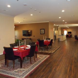 A cozy dining area with neatly arranged tables and chairs, set in a warmly lit indoor space.