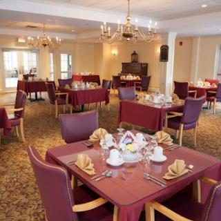 An elegantly arranged dining area with tables set for a meal.