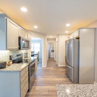 Modern kitchen with sleek appliances and bright lighting.