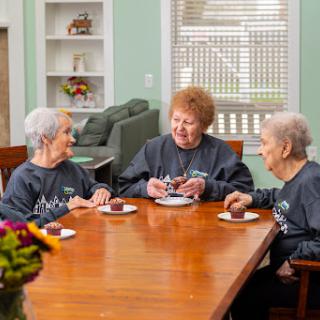 A joyful gathering of seniors enjoying each other's company over refreshments.