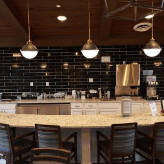 A modern coffee shop interior with a sleek counter and stylish lighting fixtures.