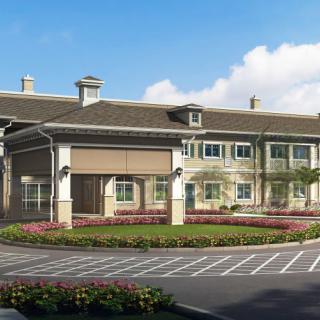 A modern commercial building with well-maintained landscaping and a parking area.