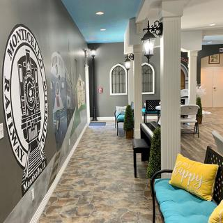 A cozy hallway with decorative murals and a comfortable seating area.