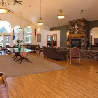 Spacious living and dining area with a fireplace and vaulted ceiling.