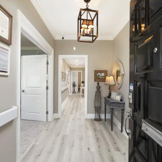 A stylish and welcoming home entrance with modern lighting and elegant decor.