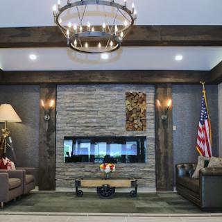 A stylish living room featuring modern decor, a cozy fireplace, and elegant chandelier lighting.