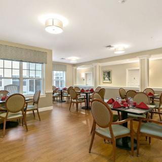 An elegantly decorated dining area with neatly arranged tables and chairs.