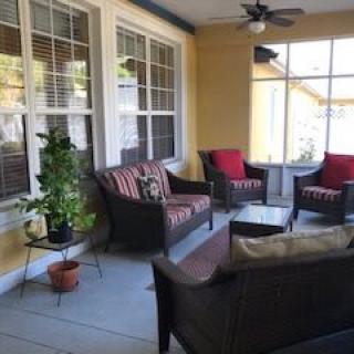 A cozy patio area with comfortable seating and plants.