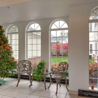 A bright conservatory with a seating area and garden view.