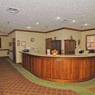 A reception area with a wooden desk and warm lighting.
