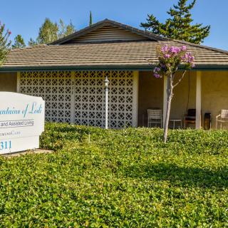 A healthcare clinic surrounded by greenery with a visible signboard.