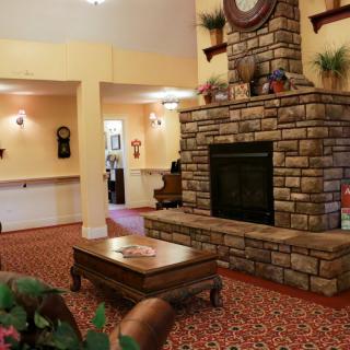 A cozy living room featuring a stone fireplace and warm decor.