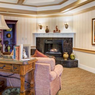 A cozy living room with a warm fireplace and comfortable seating.