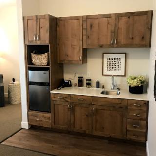 A cozy kitchen setup featuring warm wood cabinetry and modern appliances.