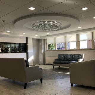 A modern lobby with comfortable seating and a stylish chandelier.
