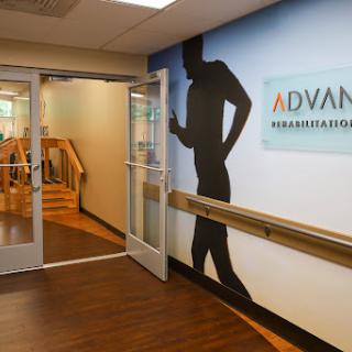 Entrance to a rehabilitation center featuring a dynamic silhouette on the wall.