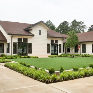 A well-landscaped front yard of a modern residential house.