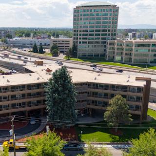 Aerial view of a city area featuring modern buildings and green landscaping.