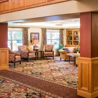 A cozy living room with comfortable seating and a patterned carpet.