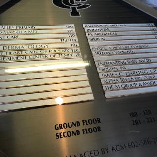 A directory sign showing office locations on the ground and second floors.