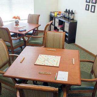 A cozy game room with tables set up for playing Scrabble.