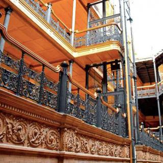 A historical building featuring intricate ironwork and ornate architectural details.