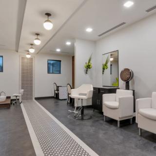 A modern salon interior with elegant lighting and comfortable seating.