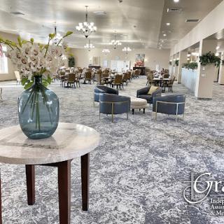 A modern lobby space featuring comfortable seating and elegant floral arrangements.
