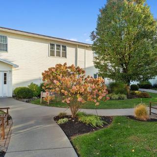 A well-maintained building exterior with a landscaped pathway and trees.