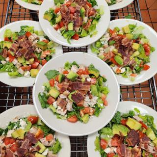 A vibrant assortment of fresh salads beautifully arranged on plates.