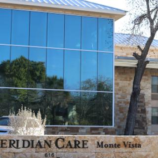 A modern healthcare facility named Meridian Care located in Monte Vista, featuring large glass windows and a contemporary design.