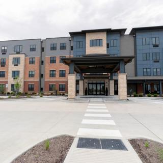 A modern apartment building with a welcoming entrance and contemporary design.
