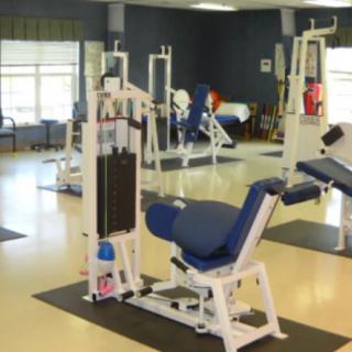 A gym with various exercise machines and fitness equipment.