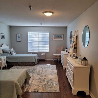 A cozy bedroom with twin beds, adorned with elegant furniture and decor elements.