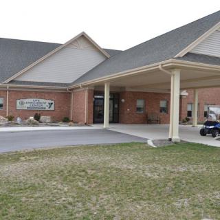 A brick building with an overhang at the entrance.